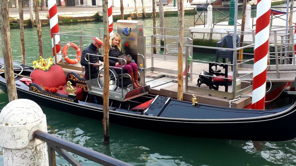 Kelly riding an accessible gondola in Venice, Italy